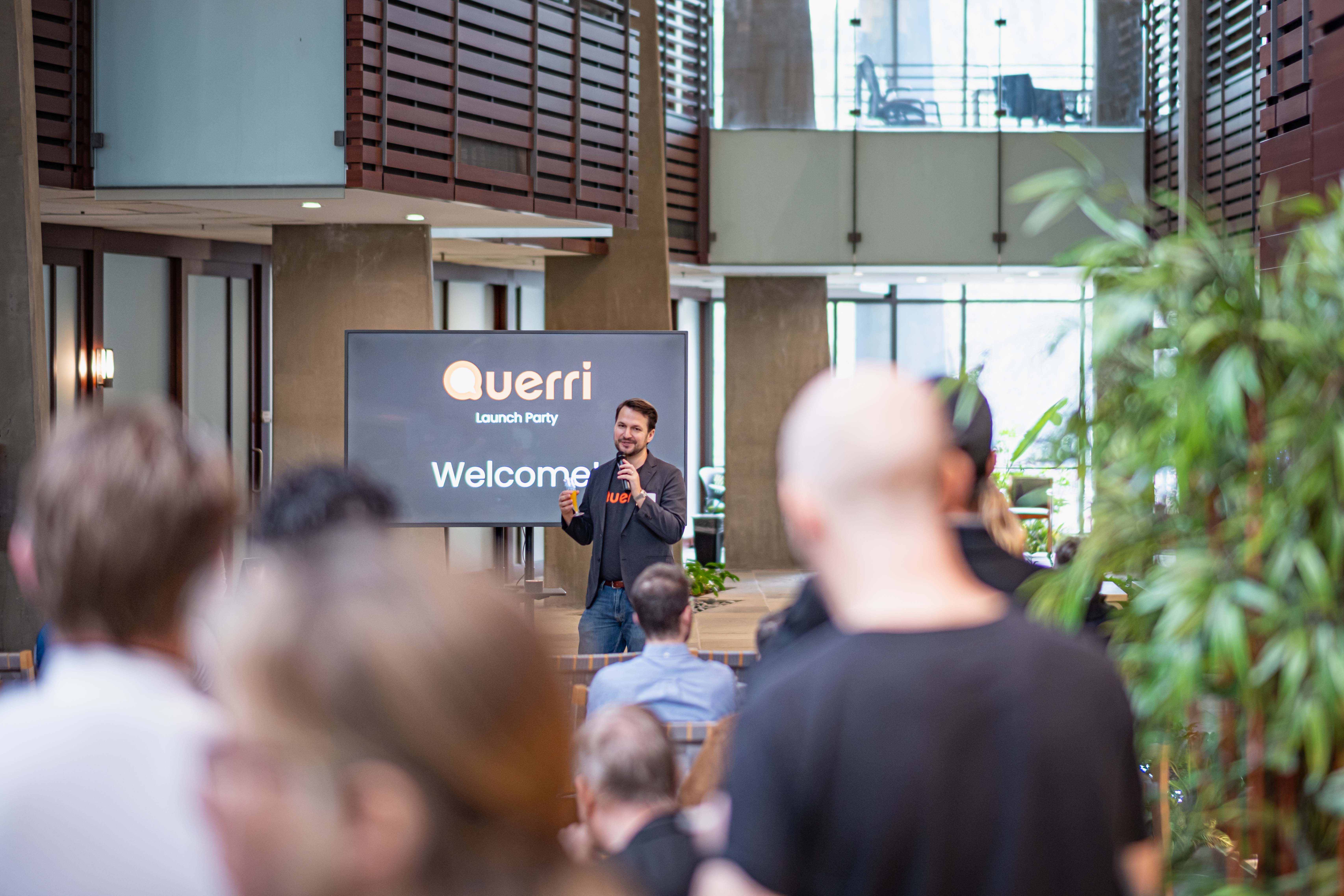 David Ingram, CEO and founder of Querri speaking in front of a crowd of people.
